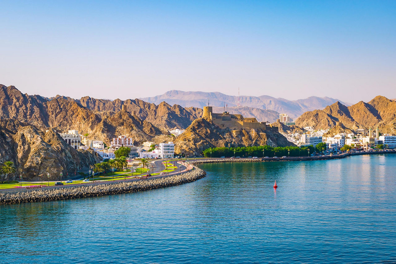 View of the waterfront coast with mountains in Muscat, Oman