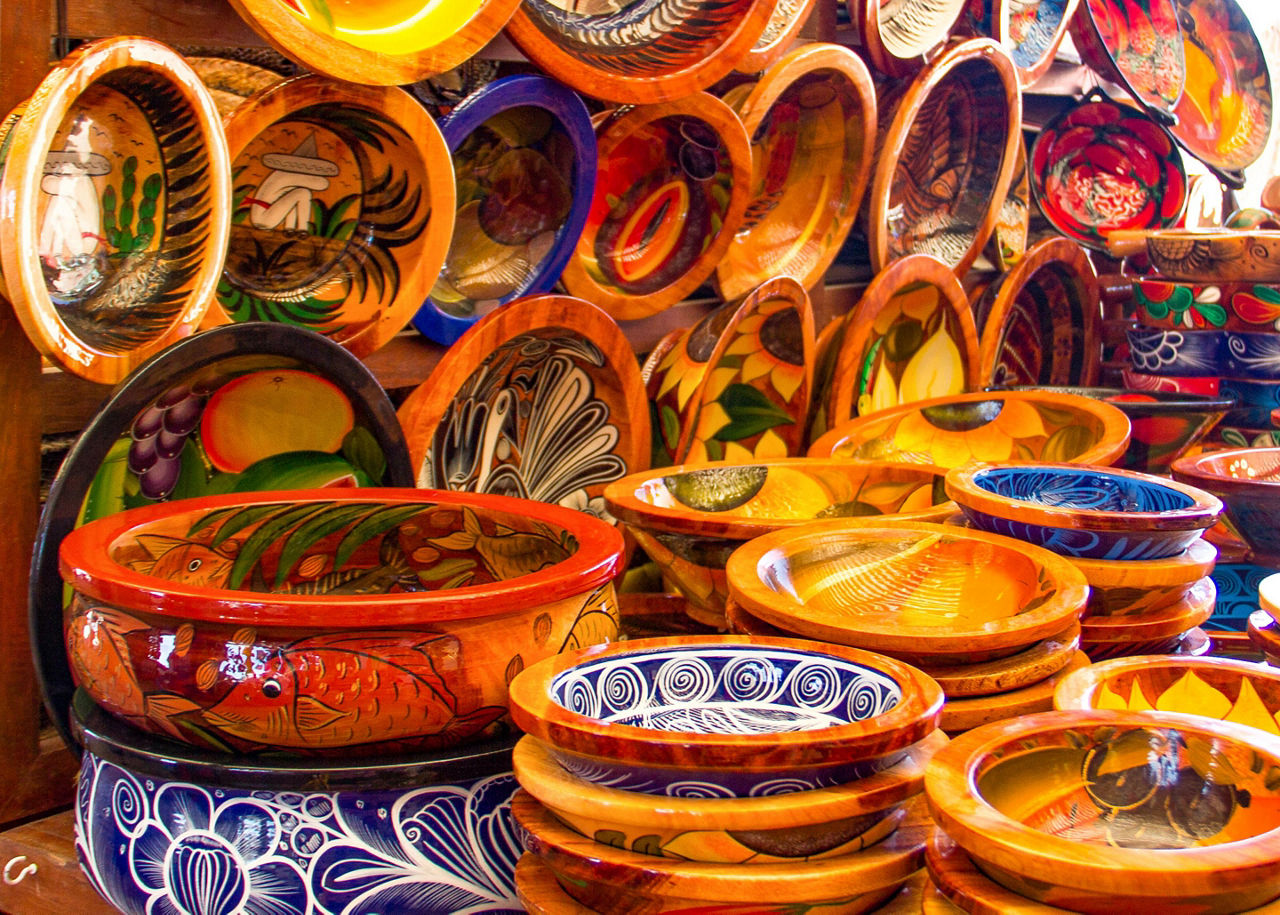 Mexican pottery in bold earthy colors and patterns at artisan market in Puerto Vallarta, Mexico