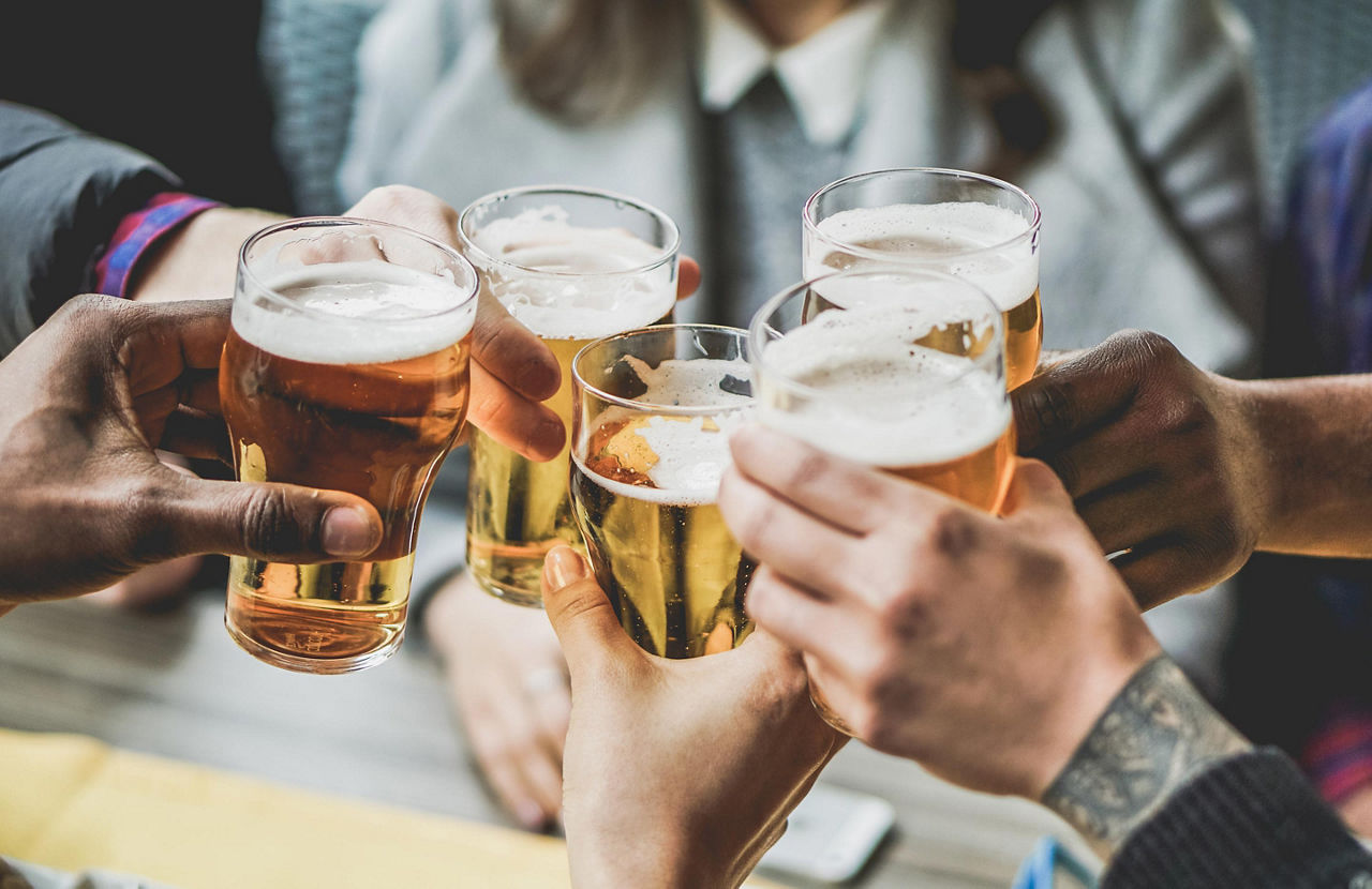 A group of friends toasting beers