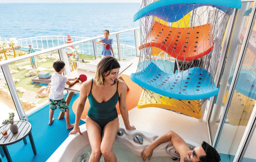 Parents in the jacuzzi on the balcony of the Ultimate Family Suite