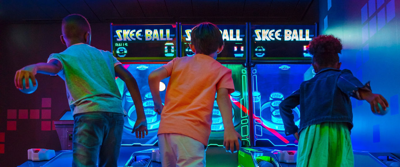 Kids Competing at Skee Ball