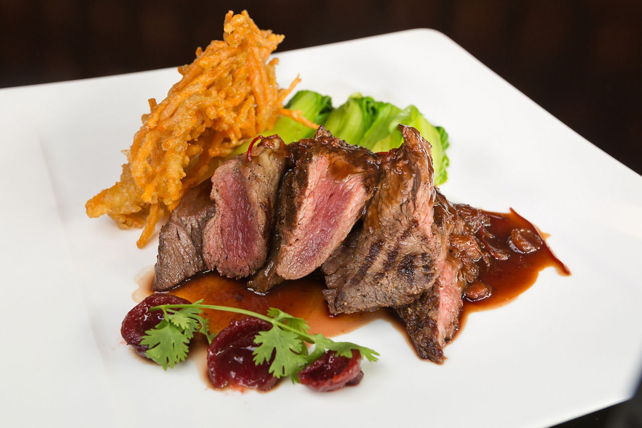 Flame grilled ,rare kangaroo steak loin, served with pak choi and a red wine sauce